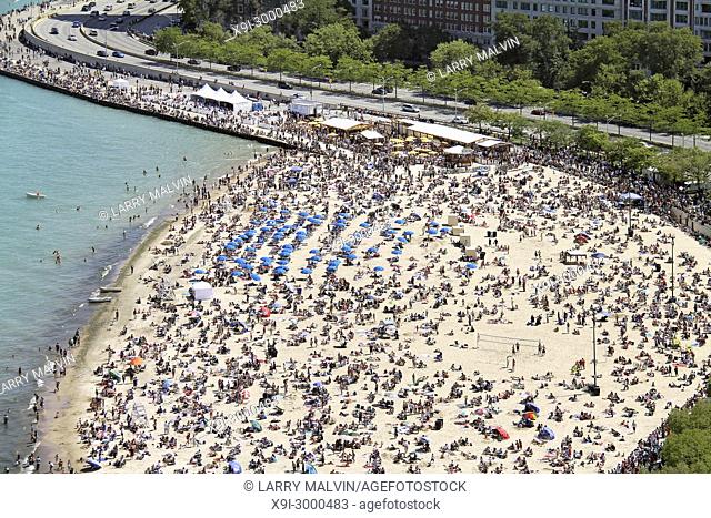 Crowded Oak Street beach in summer beside Lake Shore Drive in Chicago, IL. USA