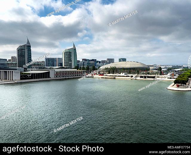 Portugal, Lisbon, Clouds over city waterfront with¶ÿTorre Sao Gabriel, ¶ÿTorre Sao Rafael and Altice Arena in background