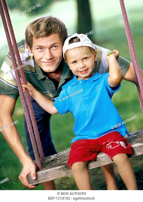 Father with son on the swing