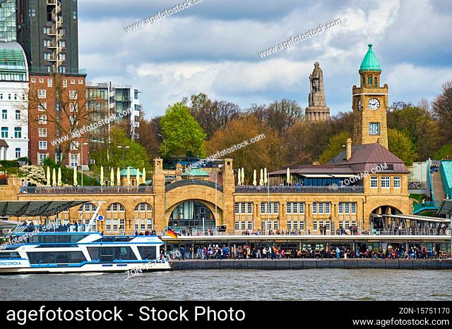 View of St. Pauli's Pier Landungsbrücken station tower with buildings and boats in Hamburg
