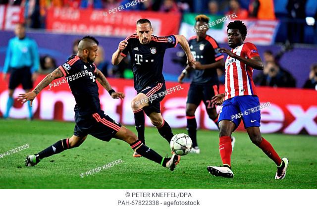 Munich's Arturo Vidal (L-R) and Franck Ribery and Madrid's Thomas Teye Partey vie for the ball during the Champions League semi-final match between Atletico...