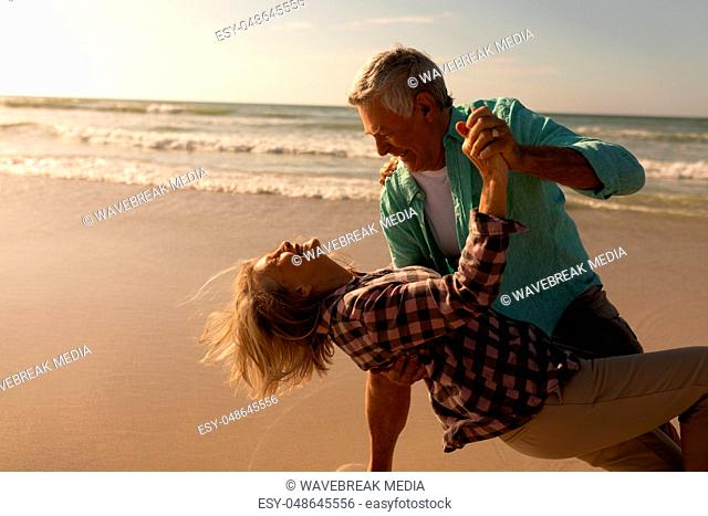 Senior couple dancing together on the beach