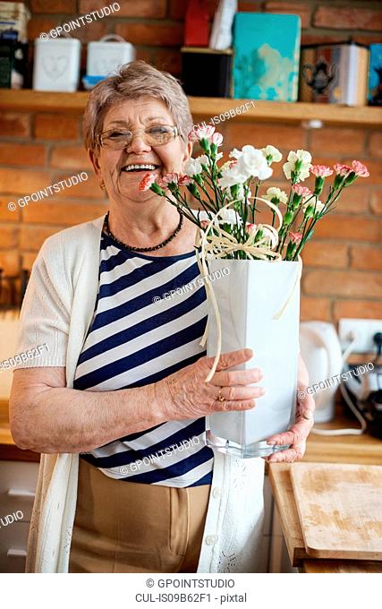 Senior adult woman with floral craftwork