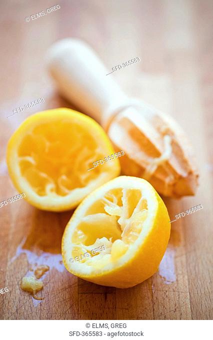 Squeezed lemon with wooden lemon reamer