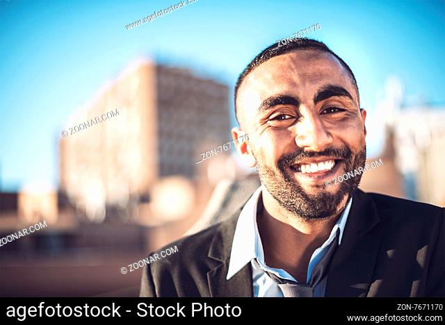 Confident attractive Arab businessman in urban environment