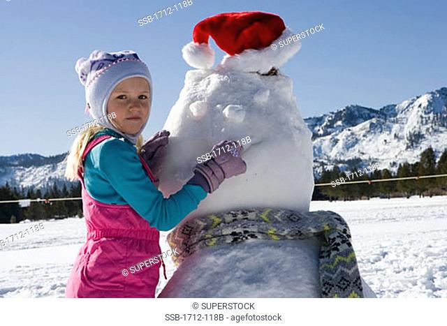 Girl building a snowman