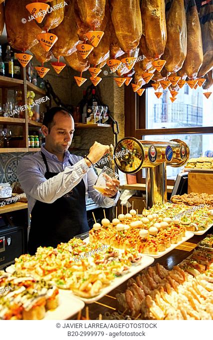 Waiter serving beer, Ham, Pintxos, Bar Restaurante Portaletas, Parte Vieja, Old Town, Donostia, San Sebastian, Gipuzkoa, Basque Country, Spain