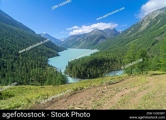The hiking trail on the hillside leading to the Kucherla lake. Altai Mountains, Russia. Sunny summer day