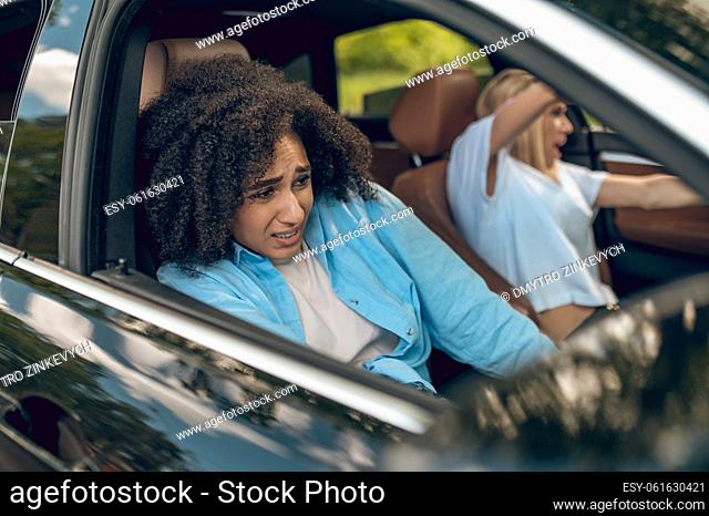 Car accident. Girls in the car having car accident and looking scared