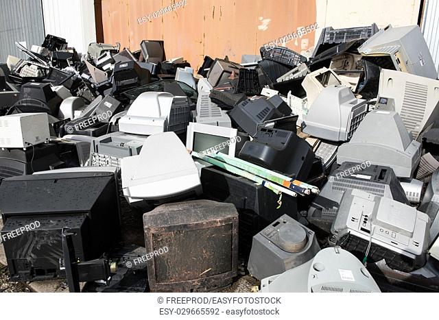 Old used and obsolete electronic equipment before a building