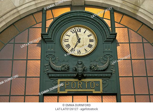 The famous clock in Sao Bento Train Station in Porto shows deocrative scroll work typical of the ealry 19th century
