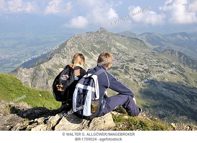 Two hiking boys on Mt. Nebelhorn, in the back Mt. Rubihorn, Allgaeu Alps, Bavaria, Germany, Europe