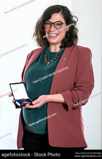 07 May 2021, Berlin: Sarah Hüttenberend from Wuppertal (North Rhine-Westphalia) stands in Bellevue Palace with the Order of Merit of the Federal Republic of...