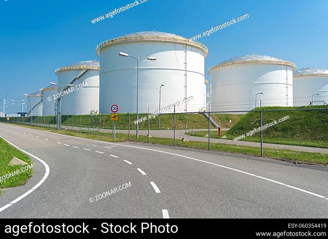 rows of large oil silos in the port of amsterdam
