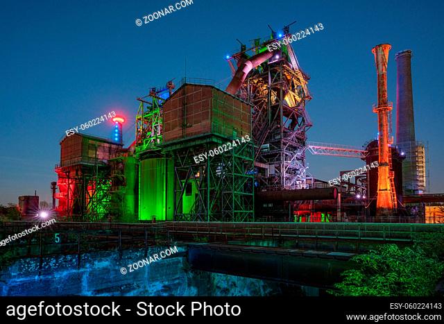 DUISBURG, GERMANY - SEPTEMBER 18, 2020: Industrial heritage of the old economy, illuminated ruin of steelmill in the Landschaftspark Duisburg on September 18