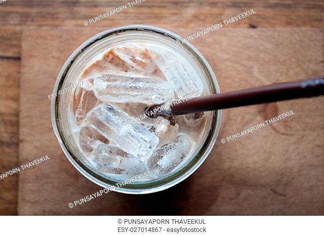 Top view of iced coffee on wooden table, stock photo