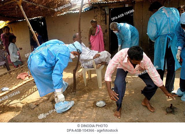 Government health workers go house to house to cull infected chickens in the backyard of the villager's houses at Hingona village in Jalgaon district as Bird...
