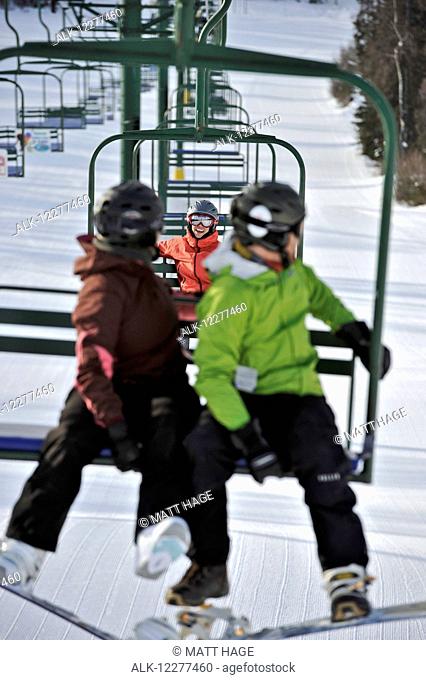 Couple ride the chair lift at Hilltop Ski Area in Anchorage, Alaska
