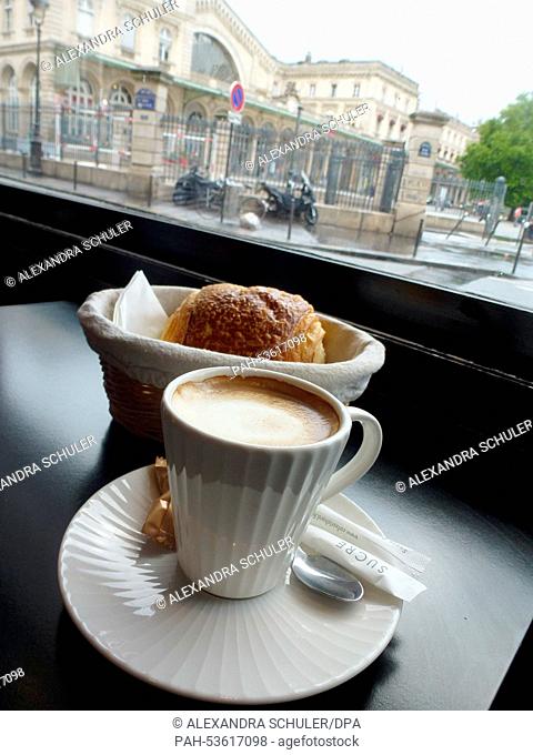 A cup of coffee and a croissant on a table at a street cafe at the Gare du Nord in Paris,  France, 27 August 2014. Photo: Alexandra Schuler - NO WIRE SERVICE -...