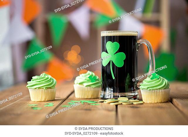shamrock on glass of beer, green cupcake and coins