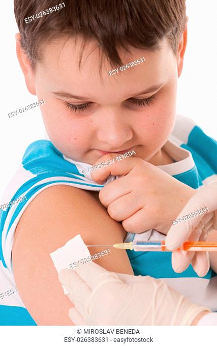 Doctor giving a child injection in arm on isolated image