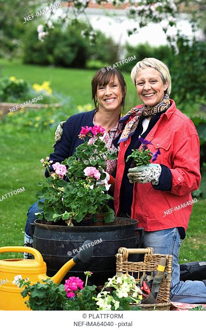 Two women setting flowers in pots Sweden