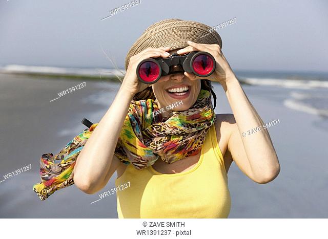 A woman in a sunhat and scarf on the beach on the New Jersey Shore, at Ocean City