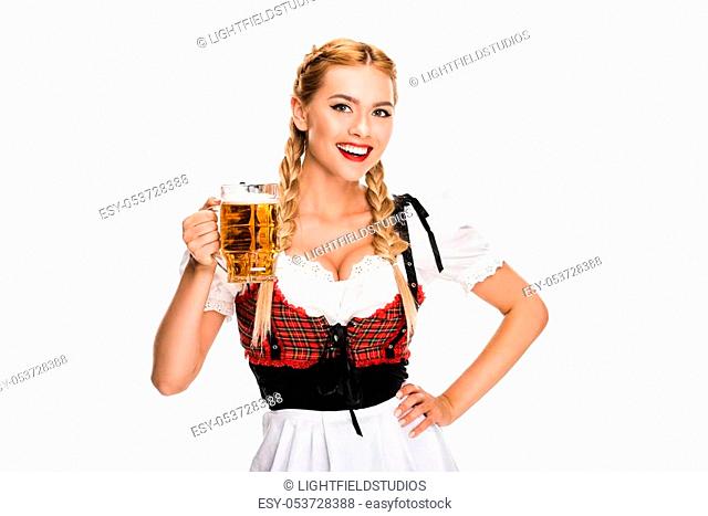 smiling waitress in traditional german costume holding beer glass on Oktoberfest, isolated on white
