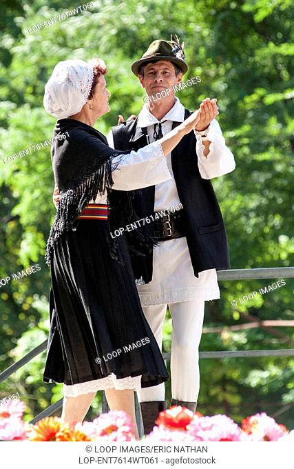 Moldovan couple in traditional costume dancing during Limba Noastra festivities in Chisinau which is the capital of Moldova in Eastern Europe