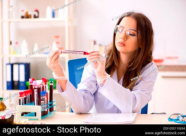 Young beautiful lab assistant testing blood samples