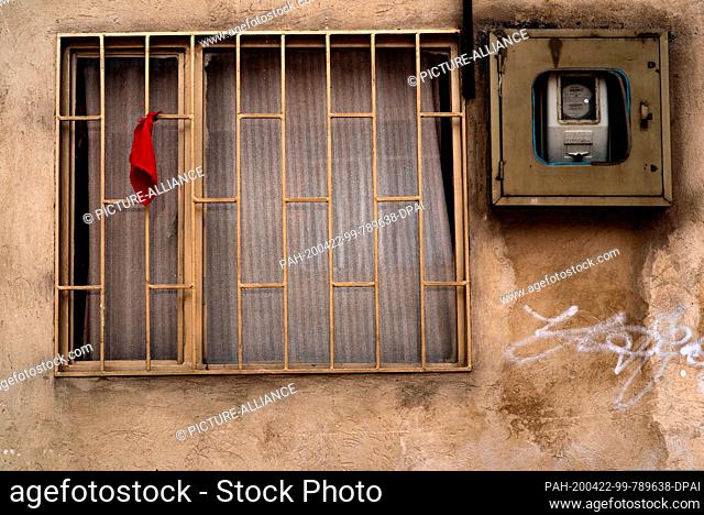 21 April 2020, Colombia, Ciudad Bolivar: A red cloth hangs from the bars of a window in the district of Ciudad Bolivar south of Bogota