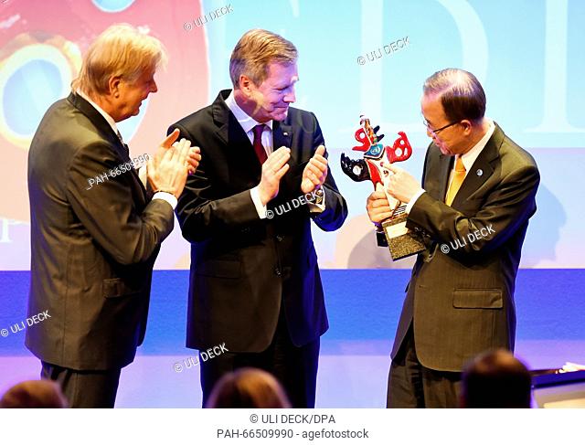 United Nations Secretary General Ban Ki-moon (R) receives the German Media Prize 2015 from former German President Christian Wulff (C) and Karlheinz Koegel