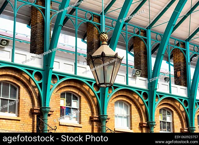 Detail of a lamp hanging from the steel roof of Covent Garden Market in London United Kingdom