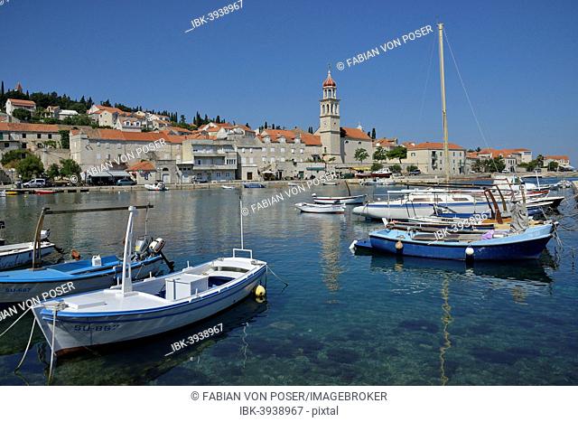 Fishing boats in the harbour in front of the church of Sveti Ivan, St Ivan, Sutivan, Island of Brac, Dalmatia, Croatia
