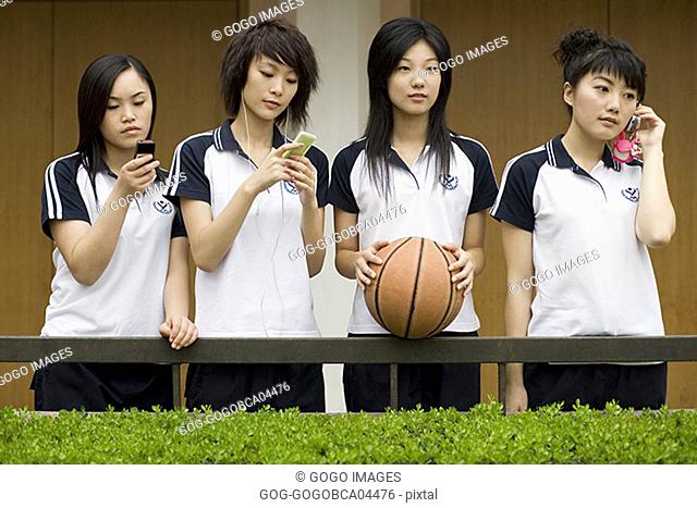 Female students using their cell phones