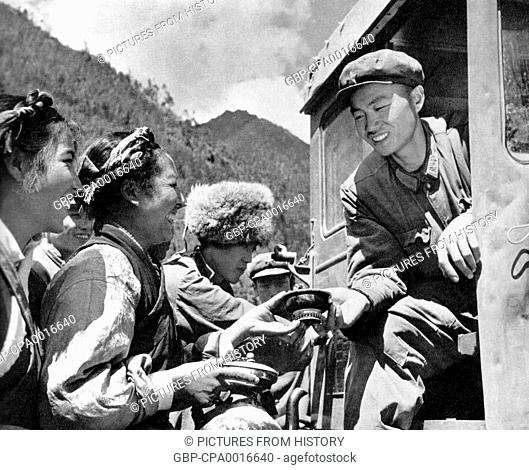 China / Tibet: Chinese propaganda image of happy Tibetans offering butter tea to a Han Chinese People's Liberation Army (PLA) tractor driver at the time of the...