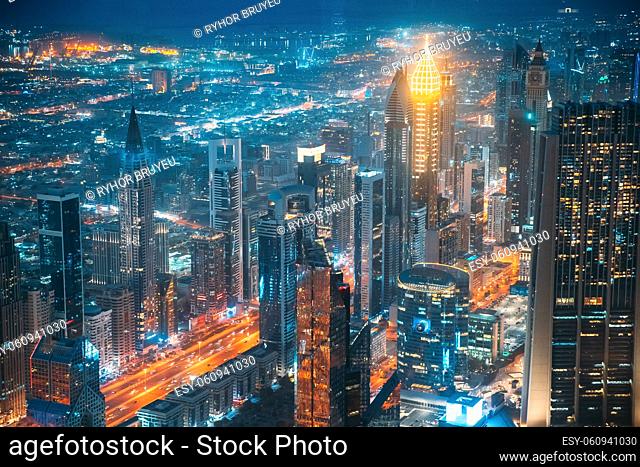 Aerial view of city background of illuminated cityscape with skyscrapers and modern urban architecture in Dubai resort town