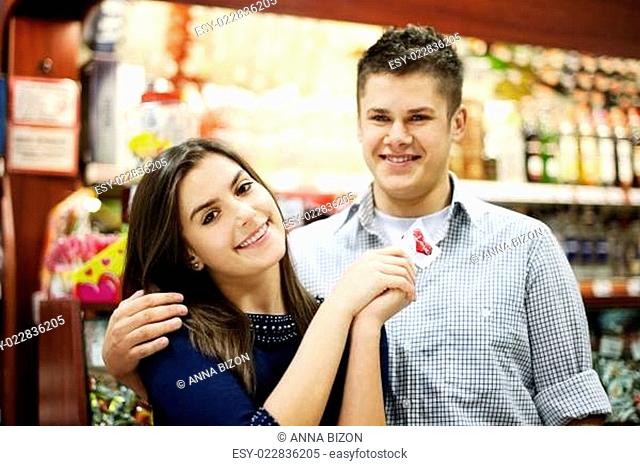 Couple holding lollipop in their hands