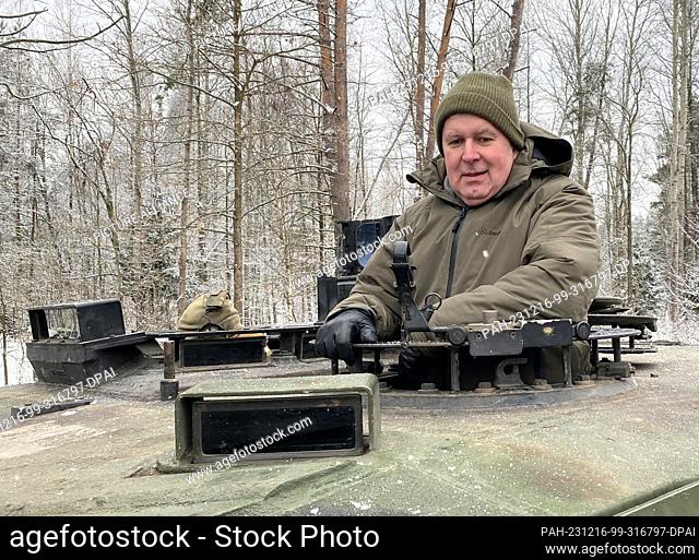15 December 2023, Lithuania, Rukla: Arvydas Anusauskas, Minister of Defense of Lithuania, rides on a Leopard 2 A6 tank at the Lithuanian military training area...