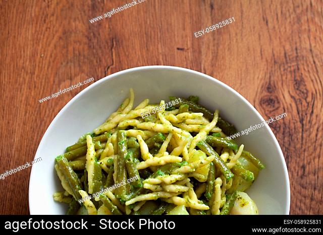 Pasta with pesto sauce on a plate