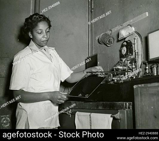 African American Private Hannah Wills developing an x-ray film in the x-ray laboratory.., 1943. Creator: Unknown