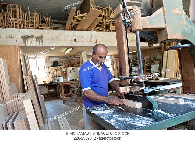 Carpenter using wood cutter in workshop Saidon Lebanon