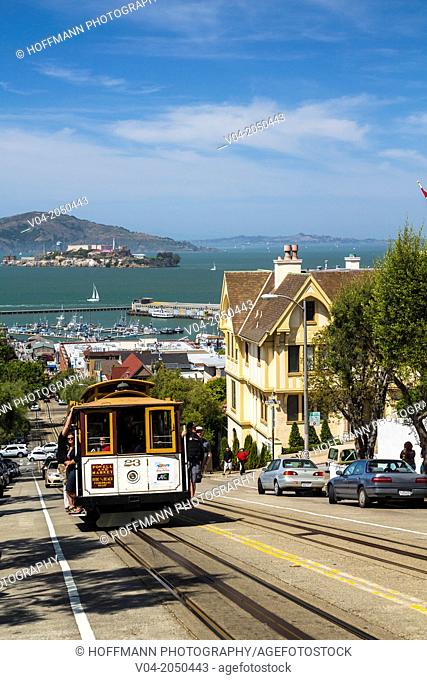 Famous cable car with Alcatraz island in the background, San Francisco, California, USA