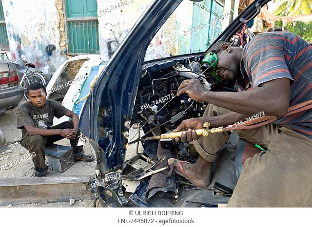 Welders reparing car, Stone Town, Zanzibar, Tanzania, Africa