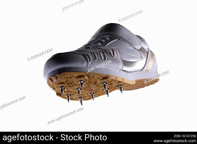 Sports shoes on a white background. White sneaker with spikes. Leather running shoes
