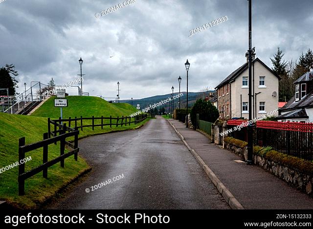 FORT AUGUSTUS, SCOTLAND, DECEMBER 17, 2018: View of the road aside the Caledonian Canal while a bird flies on a cloudy day