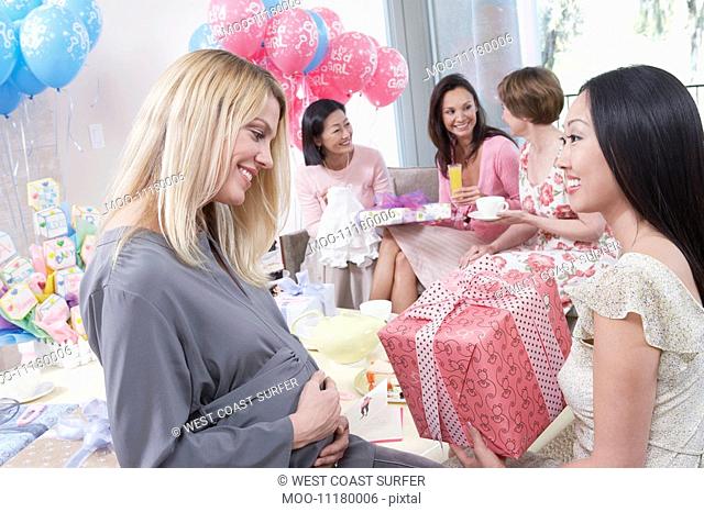 Woman giving gift at baby shower