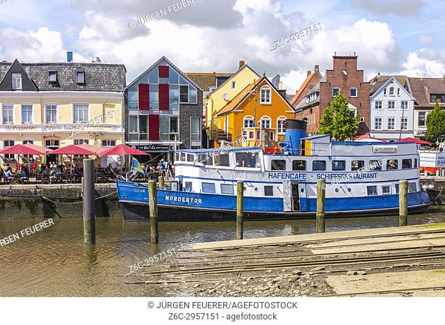 boat restaurant of an old steamboat at the inner harbour of the coastal town Husum at the North Sea, Germany