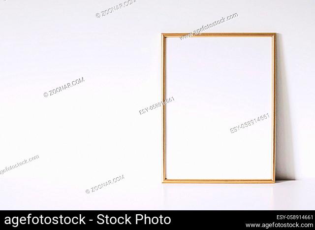 Golden vertical frame on white furniture, luxury home decor and design for mockup creations