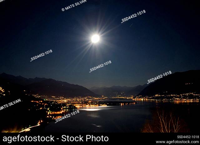 Moon Light over Ascona and Alpine Lake Maggiore with Mountain at Night in Ticino, Switzerland